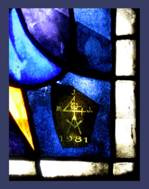 Masonic symbol of an angle over a compass, the top and bottom points of the angle incribed with the letter J, the center of the angle inscribed with the letter M